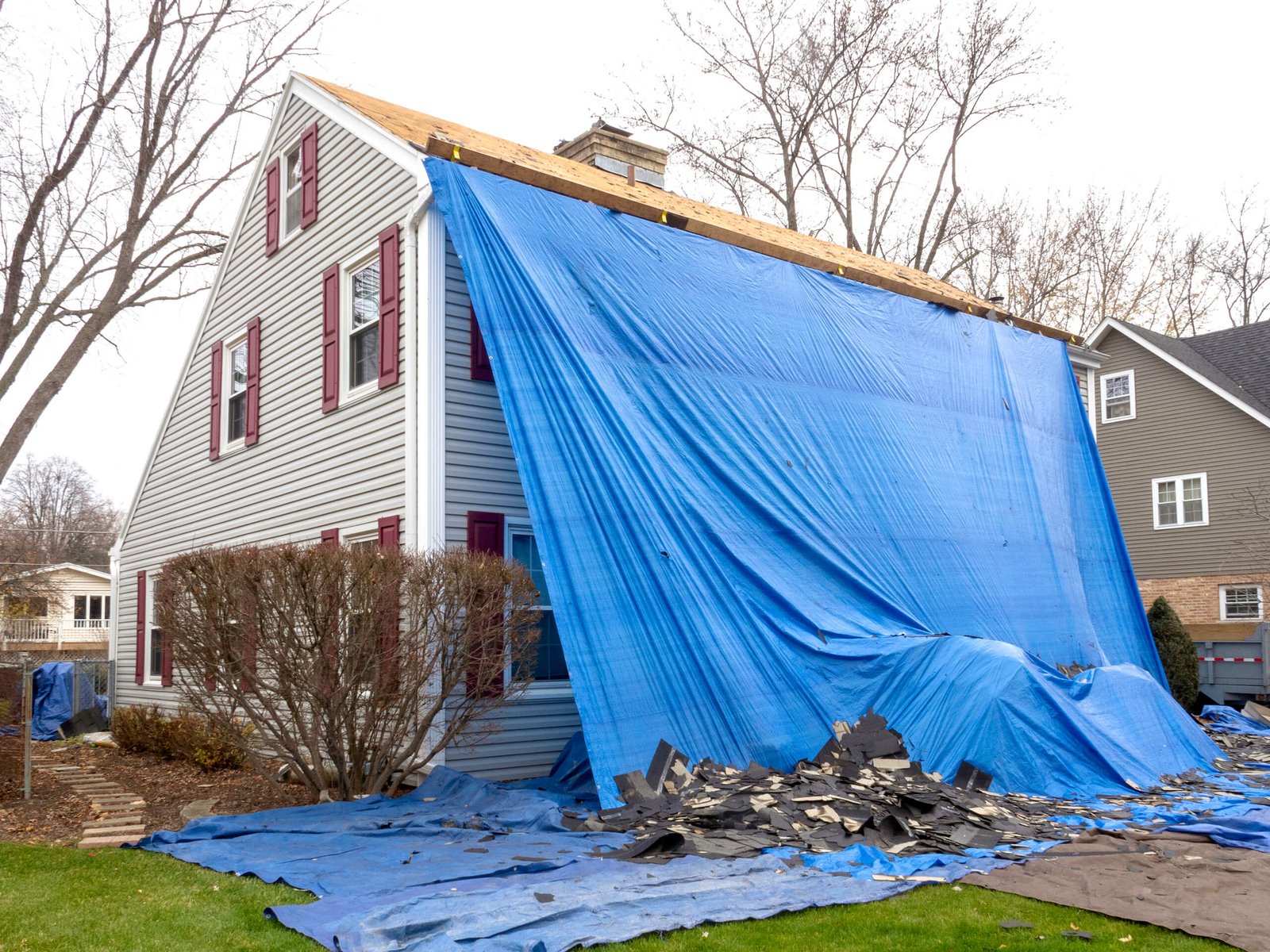 Pile of shingles laying on tarp during a roof replacement